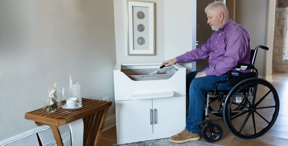 Wheelchair user scooping an accessible elevated cat litter box