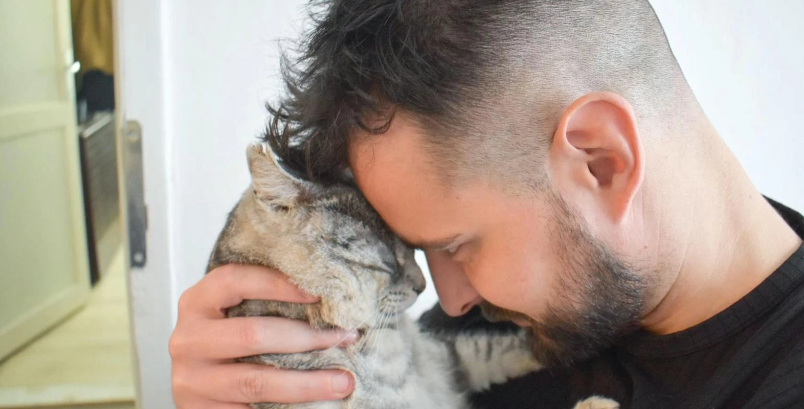 Man holding a cat for the LoftyLoo charitable giving page