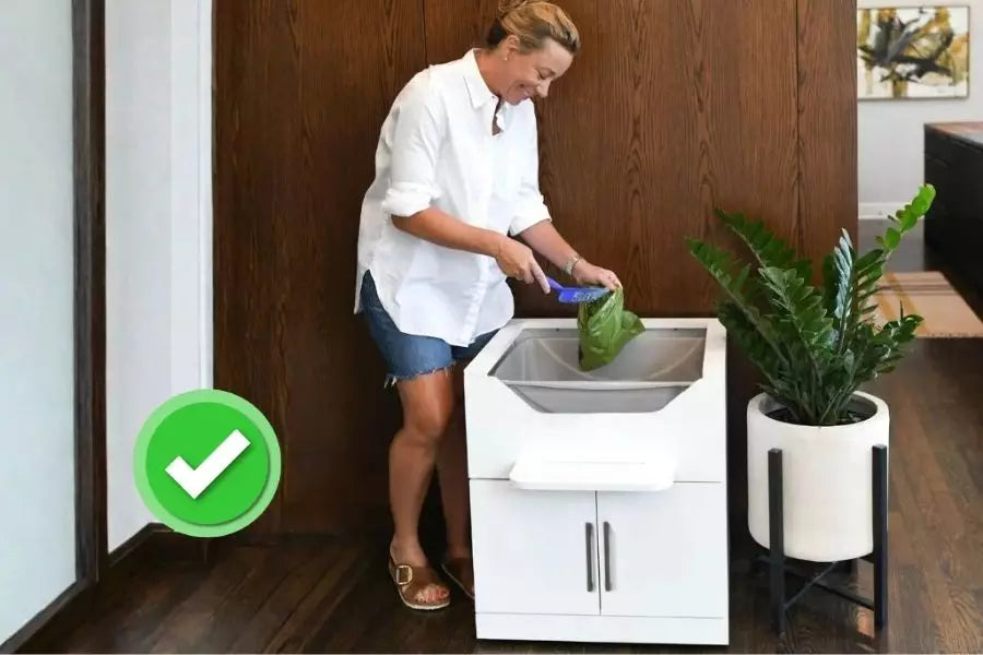 Woman standing to scoop LoftyLoo cat litter box